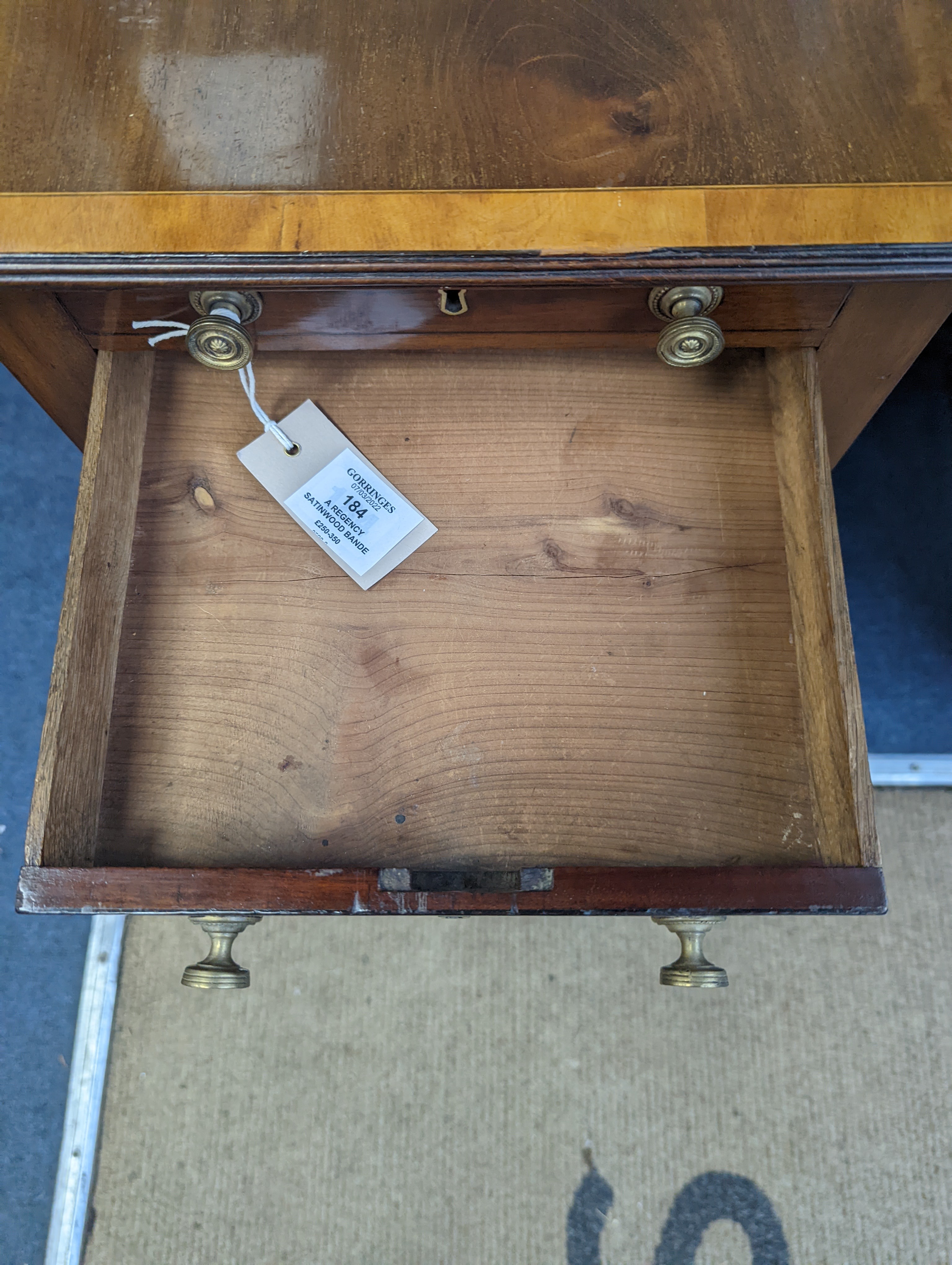 A Regency satinwood banded mahogany drop flap work table, width 69cm extended, depth 46cm, height 76cm